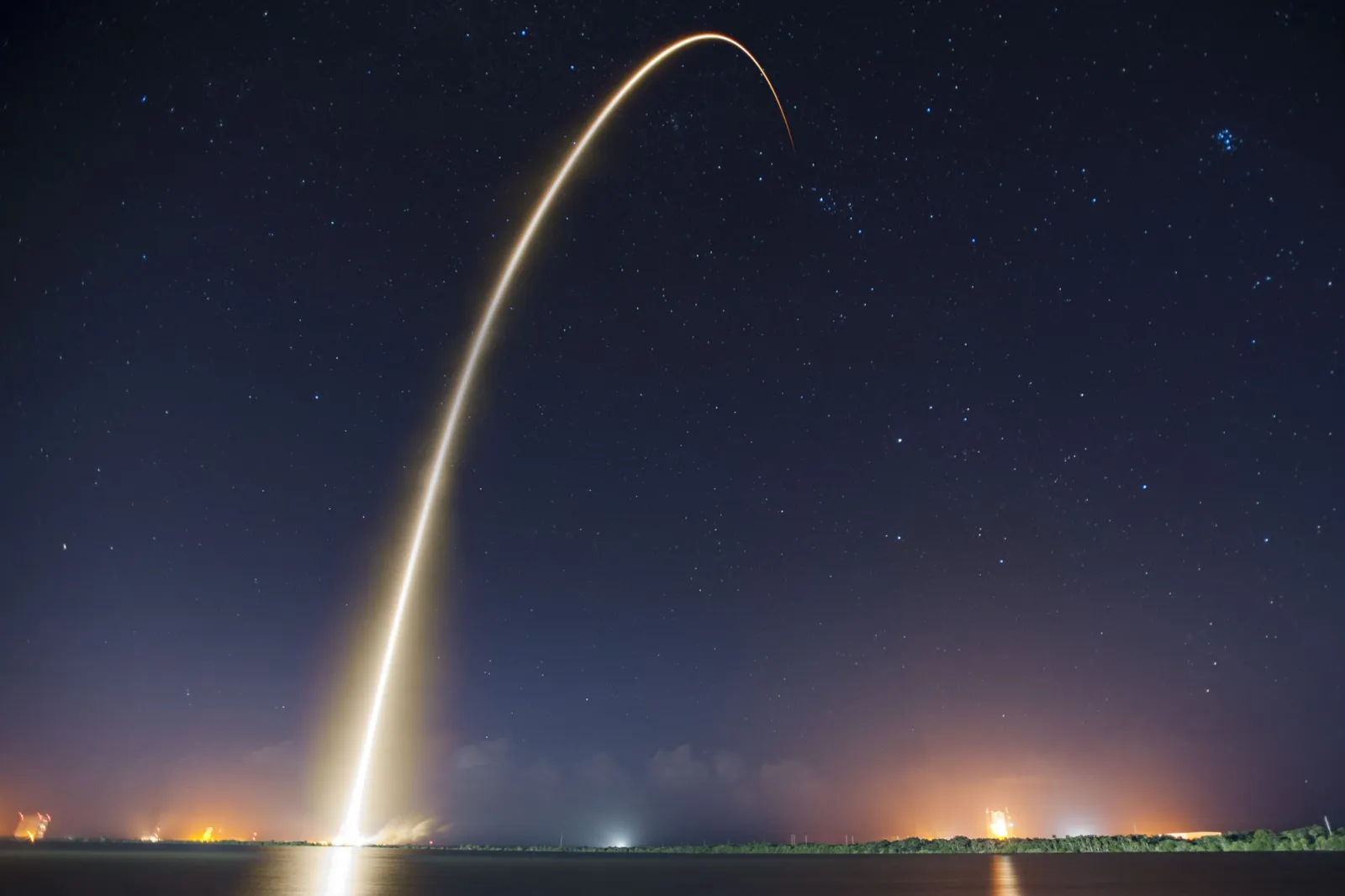 Rocket launch trail against a blue sky