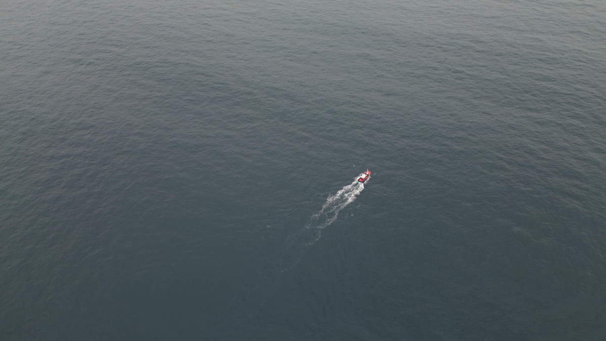 Sailboat on the open Atlantic under a wide sky