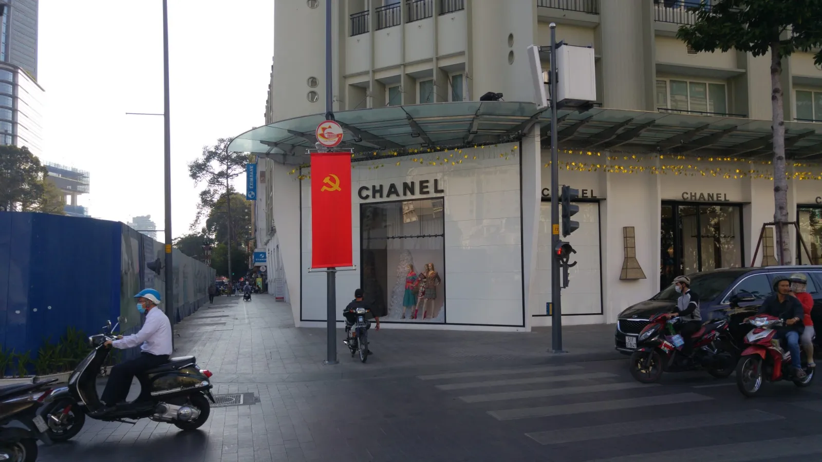 Street scene in Ho Chi Minh City with banners and everyday urban life